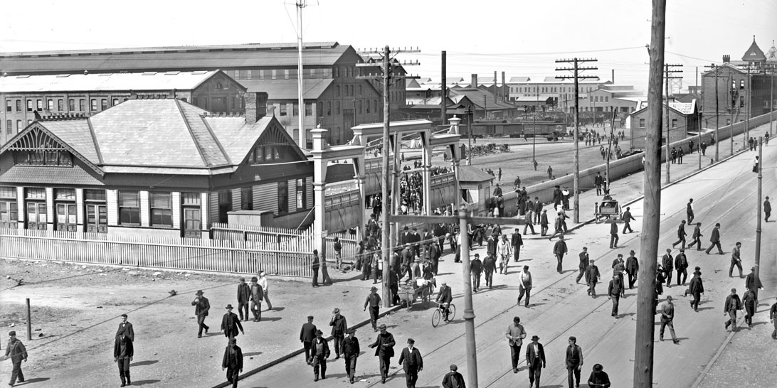 WORKERS LEAVE MAIN GATE DURING LUNCH HOUR