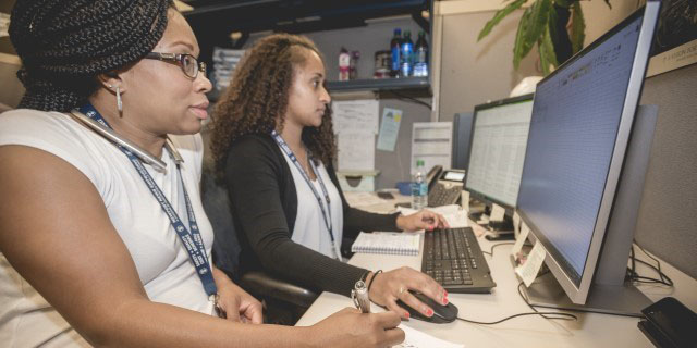 two-females-desk-working-cropped